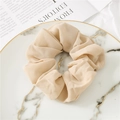 Minimalist beige chiffon scrunchie with soft fabric texture on a marble decorative plate - Khaki