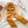 Detail of ginger yellow waffle fabric scrunchie with long ribbon bow on decorative tray - Yellow Ribbed
