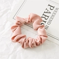 Pink satin scrunchie with glossy texture displayed on a Weekend in Paris card - Pink