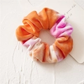 Detail of velvet tie-dye scrunchie in orange and pink with soft plush texture - Orange Tie-Dye