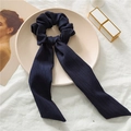 Dark blue waffle knit scrunchie with long bow ribbon streamers on a white plate - Dark Navy Ribbed