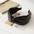 Cerchietto largo con nodo in ecopelle nera con texture PU raffinata su una rivista - Nero