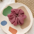 Pink textured bubble fabric scrunchie on a decorative plate for hair styling - Seersucker Dusty Pink