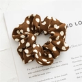 Macro detail of brown polka dot fabric scrunchie with fine ribbed texture and soft folds - Coffee With Polka Dots