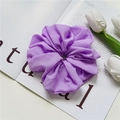 Macro detail of purple pleated oversized scrunchie on a magazine with white tulips - Purple