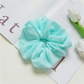 Detail view of a mint green chiffon oversized hair scrunchie with soft pleated texture - Blue
