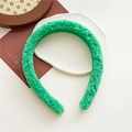Top view of fluffy green velvet headband on a white plate with vintage autumn aesthetic - Green Headband