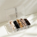 Five elastic hair ties in neutral tones stored in a transparent organizer box - Coffee Colors