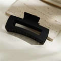 Detail view of large matte black square claw clip on natural stone background - Matte Black