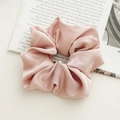 Close-up of wide satin scrunchie in dusty rose with elegant folds and silk texture - Satin Pink