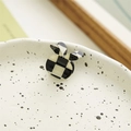 Detail of a rabbit-shaped hair claw clip with black and white checkerboard pattern texture - Little Rabbit