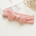 Vue détaillée du bandeau pour bébé en maille rose avec un grand nœud décoratif sur blanc - Bandeau à Nœud Rose