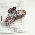 Detail view of large acetate hair claw clip with colorful leopard pattern and strong teeth - Colorful Leopard Print