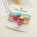 Set di 5 elastici per capelli colorati con toppe a sorriso su scheda di presentazione - Stile Sorridente