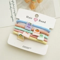 Detail of 5-piece candy-colored elastic hair ties with cute woven fruit pattern labels - Fruit Style