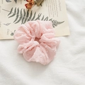 Pink seersucker hair scrunchie with white polka dots shown on vintage floral background - Swiss Dot Pink
