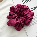 Macro shot of oversized glossy satin scrunchie in deep magenta with elegant silk texture - Thin Style / Burgundy