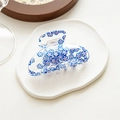 Detail of transparent acrylic hair claw clip with blue floral pattern on decorative plate - Shark Clip Blue Floral