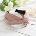 Detail of dusty pink PU leather headband with criss-cross knot on white linen background - Matte Pink