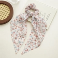 Detailed view of pink floral ribbon scrunchie with delicate chiffon fabric and patterns - Pink Floral