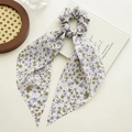 Detail of light blue floral scrunchie with long ribbons on a decorative background - Purple Floral