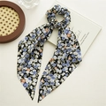 Close-up of black floral chiffon hair scrunchie with long ribbons on wooden tray - Black Floral