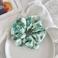 Detail of light green floral scrunchie in crepe fabric on a ceramic plate - Green Big Floral
