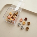Detailed view of star-shaped mini hair clips in morandi colors on a beige tray - Colorful Star