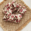 Floral scrunchie with red roses and cream fabric on a woven rustic background - Pink And White Rose