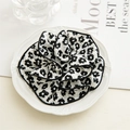 Elegant floral scrunchie with black and white daisy pattern and stitched edging finish - Small White Flower