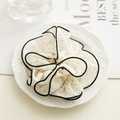 Elegant white polka dot scrunchie with black ruffled edges for a stylish hair accessory - White Polka Dot