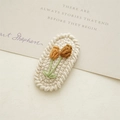 Handmade knitted hair clip featuring cream base with orange and brown tulip embroidery - White Lace Cherry