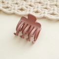 Matte dusty pink hair claw clip close-up showing resin material and rounded teeth detail - Pink