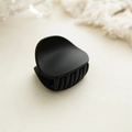 Detail of matte black heart-shaped hair claw clip with dense teeth for hair styling - Matte Black