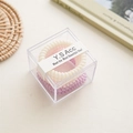 Close-up of pink, cream, and purple spiral hair ties in a transparent square gift box - Yellow Pink Purple (Fine Telephone Wire)