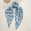 Detailed view of floral scrunchie with long ribbons in blue chiffon fabric - Petal Blue Streamer