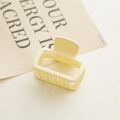 Macro detail of creamy yellow matte rectangular hair claw clip with cutout design - Milky Yellow