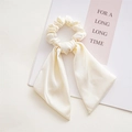 Detailed view of elegant cream satin scrunchie with long ribbons and silky texture - Knotted Beige