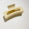 Macro view of a matte cream-colored large square hair claw clip with a strong spring hinge - 11cm / 11cm Rubber Paint Creamy White