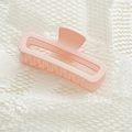 Detail view of pink matte hair claw clip for thick hair on white textured background - Cream Pink