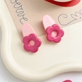 Set de dos clips para el pelo con flores rosa y magenta sobre bandeja blanca ondulada - Clip Rosa