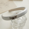 Silver faux leather headband featuring three star charms on a glass display - Star Silver Headband