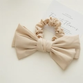 Detail view of large double-layer beige satin bow scrunchie with soft fabric texture - Khaki
