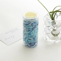 Blue and white high-elasticity hair ties in a clear cylindrical container with yellow lid - Blue Canister