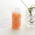 High-elastic hair ties in orange, yellow, and white colors stored in a transparent jar - Orange Canister