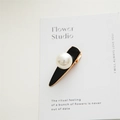 Detail shot of an elegant water-drop hair clip with a large pearl and black enamel finish - Pearl Black