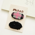 Detail of cute fabric oval hair clips in grey weave and black textured patterns - Black and Pink Plaid