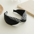 Detailed view of elegant houndstooth and black fabric knotted headband on a beige surface - Double Fabric Houndstooth Black