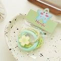Detail of colorful elastic hair tie set including mint green scrunchie and floral charm - Green