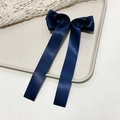 Detail of dark blue satin bow hair clip with long ribbons on a textured background - Navy Blue
